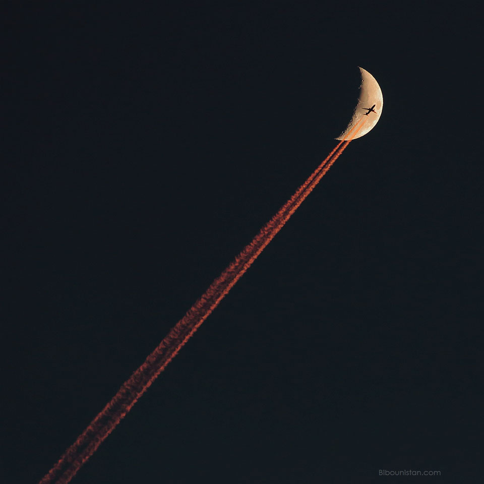 Plane Crossing a Crescent Moon