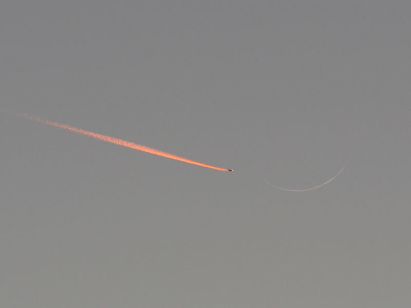 Jet Approaching a Crescent Moon